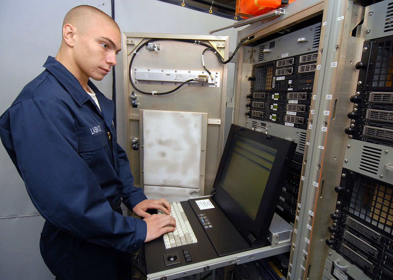 1280px-US_Navy_080823-N-9079D-037_Information_Systems_Technician_Seaman_Joel_V._Lasko,_from_Salisbury,_Conn.,_performs_backups_on_Centrixs_in_the_tactical_automated_information_systems_center_aboard_the_aircraft_carrier_USS_Abraham_Li.jpg